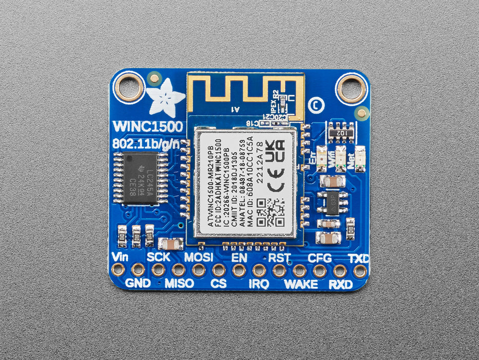 Angled shot of blue, square WiFi breakout board.