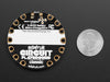 Video of a round microcontroller with lit up LEDs.