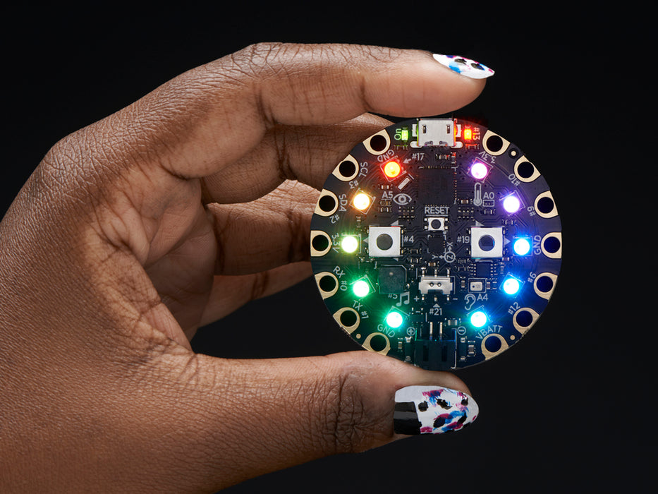 Video of a round microcontroller with lit up LEDs.