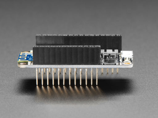 Angled shot of an Assembled Adafruit Feather M0 WiFi with Stacking Headers.