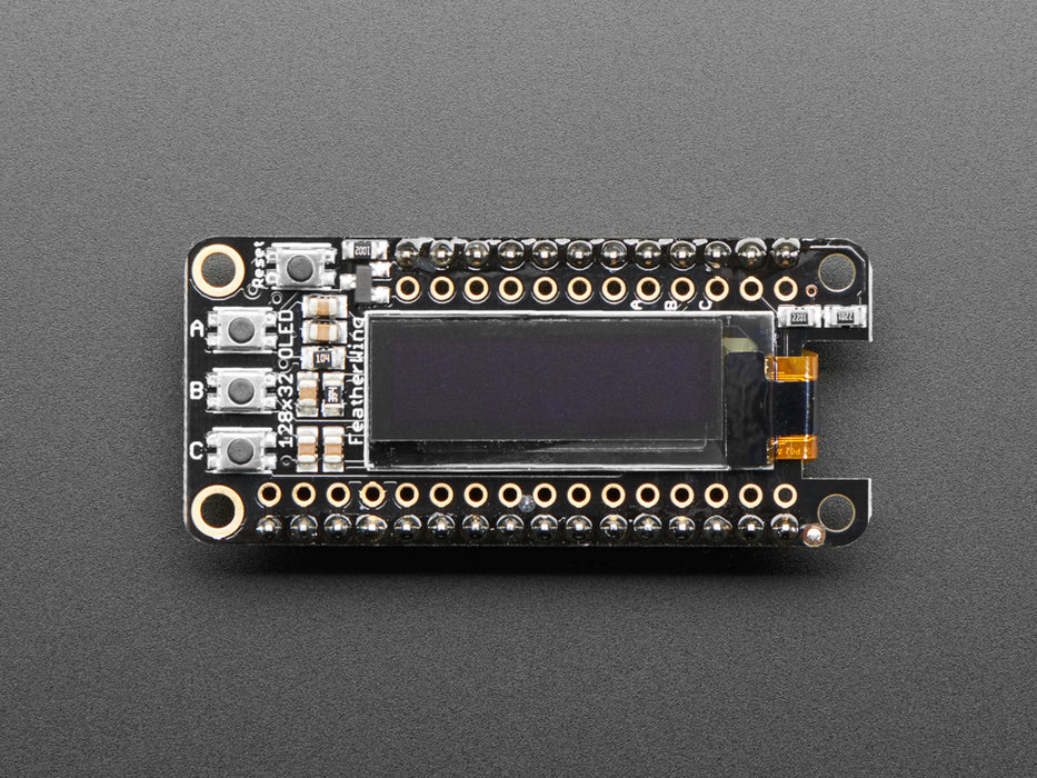 Angled shot of a Assembled Adafruit FeatherWing OLED - 128x32 OLED Add-on For Feather. 