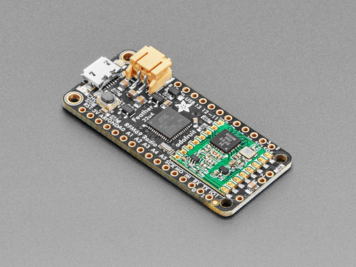 Angled shot of a rectangular microcontroller connected to a white breadboard and a lithium battery. 