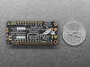 Angled shot of a rectangular microcontroller connected to a white breadboard and a lithium battery. 