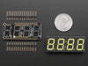 Angled shot of a rectangular shaped 7-segment breakout board with an LED matrix soldered on.