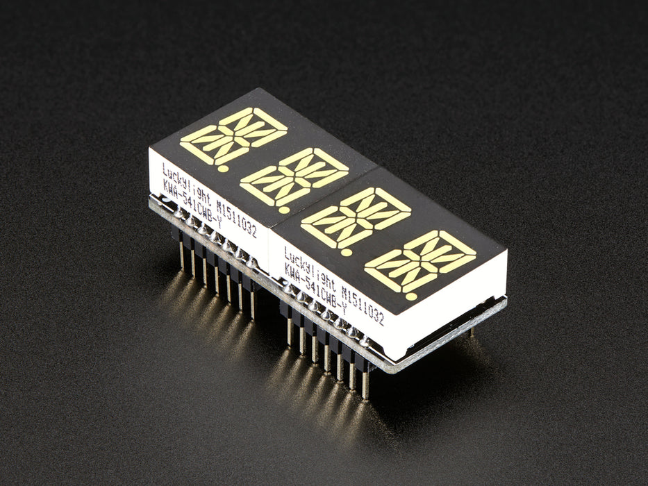 Angled shot of a rectangular shaped Quad Alphanumeric Display breakout board with an LED matrix soldered on.