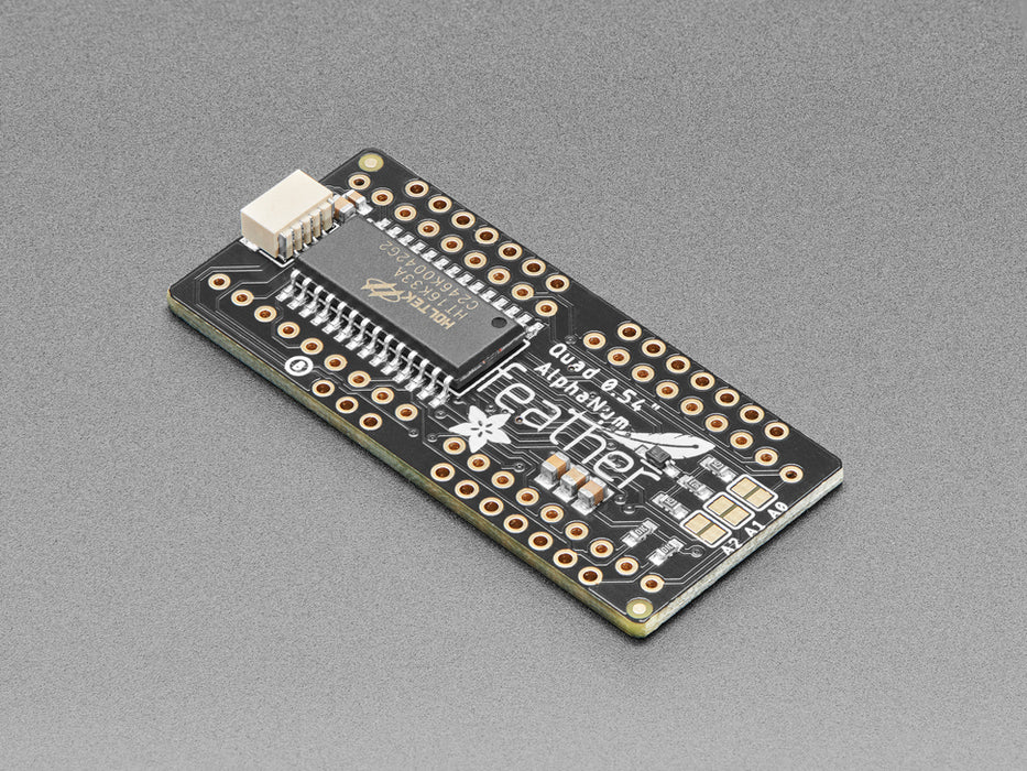 Angled shot of a rectangular shaped Quad Alphanumeric Display breakout board with an LED matrix soldered on.