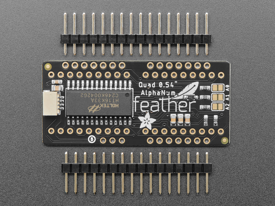 Angled shot of a rectangular shaped Quad Alphanumeric Display breakout board with an LED matrix soldered on.