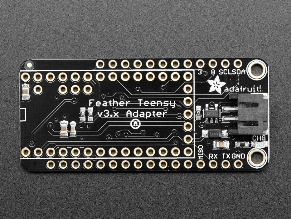 Angled shot of a black rectangular microcontroller adapter board assembled with an even smaller green microcontroller board.