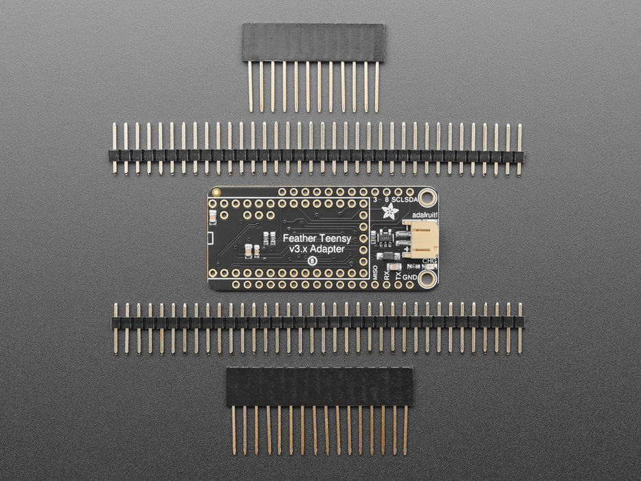 Angled shot of a black rectangular microcontroller adapter board assembled with an even smaller green microcontroller board.