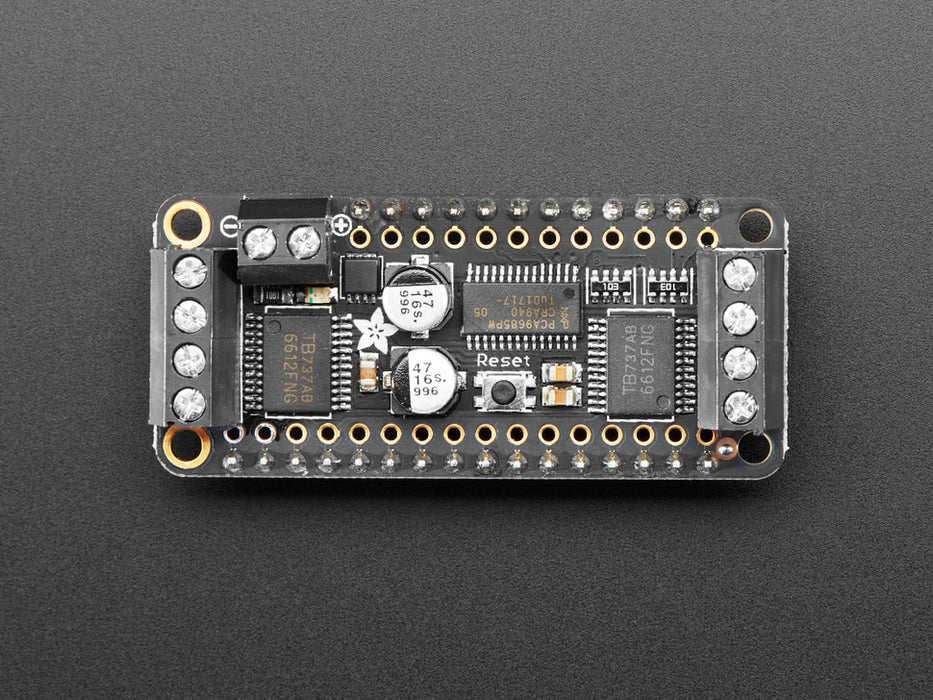 Angled shot of a Assembled DC Motor + Stepper FeatherWing Add-on. 