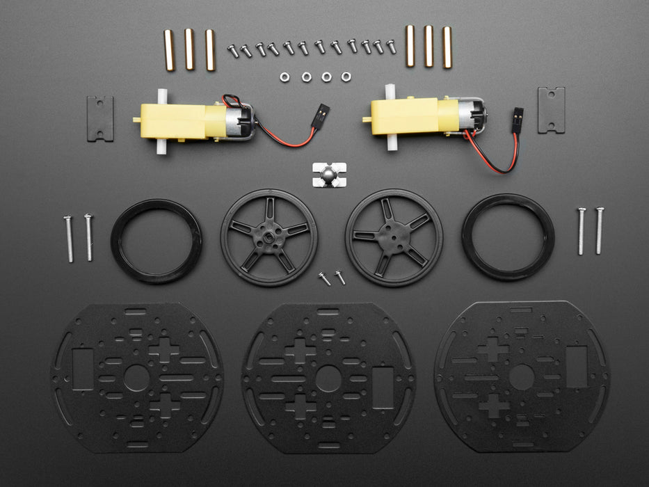 Angled shot of three-layer round robot in black metal with Feather plus motor featherwing connected to motors.