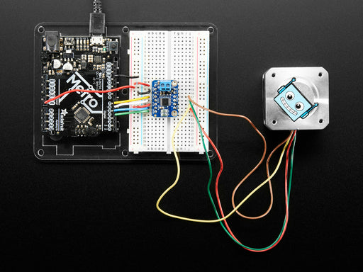 Video of a Adafruit DRV8833 DC/Stepper Motor Driver Breakout Board connected to a half sized white board powering a stepper motor with a adabot head spinning on it. 