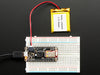 Angled shot of rectangular microcontroller with headers. 