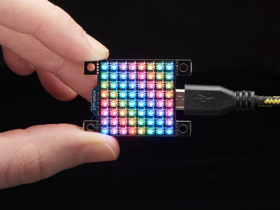 Hand holding small Adafruit DotStar High Density 8x8 Grid - 64 RGB LED Pixel Matrix