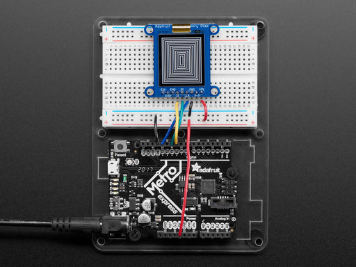 Top down view of a Adafruit SHARP Memory Display Breakout connected to a half-sized white breadboard. 