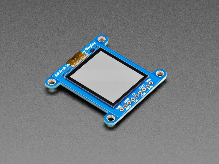 Top down view of a Adafruit SHARP Memory Display Breakout connected to a half-sized white breadboard. 