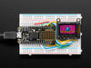 TFT breakout wired up on breadboard, showing colorful image