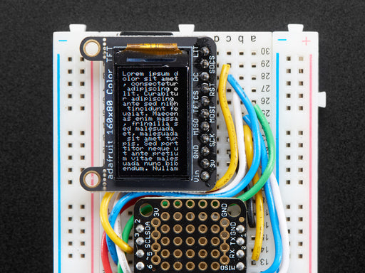 TFT breakout wired up on breadboard, showing colorful image