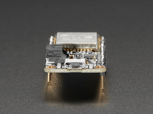 Angled shot of rectangular microcontroller with headers. 