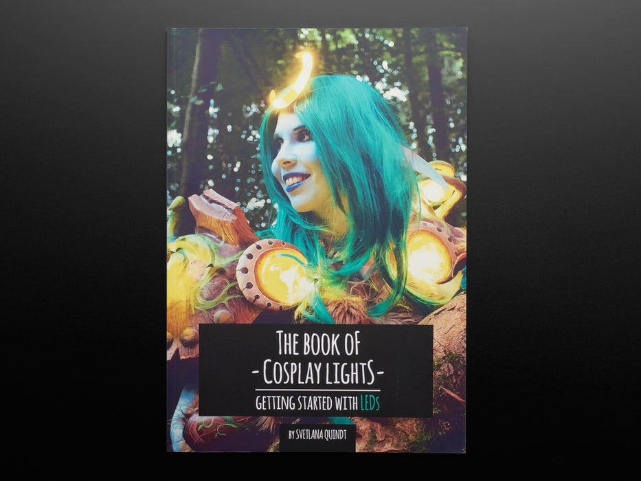 Front cover of The Book of Cosplay Lights - Getting Started with LEDs - by Svetlana Quindt @KamuiCosplay. A World of Warcraft cosplayer wearing a teal wig and costume orbs with LEDs.