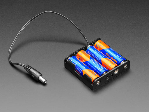 Angled shot of 4 x AA battery holder with 2.1mm plug filled with four AA batteries.