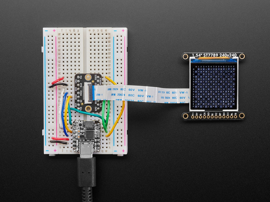 Overhead video of OLED breakout wired up on breadboard to QT Py and BFF driver board. Video displays multi-colored shapes and animations.