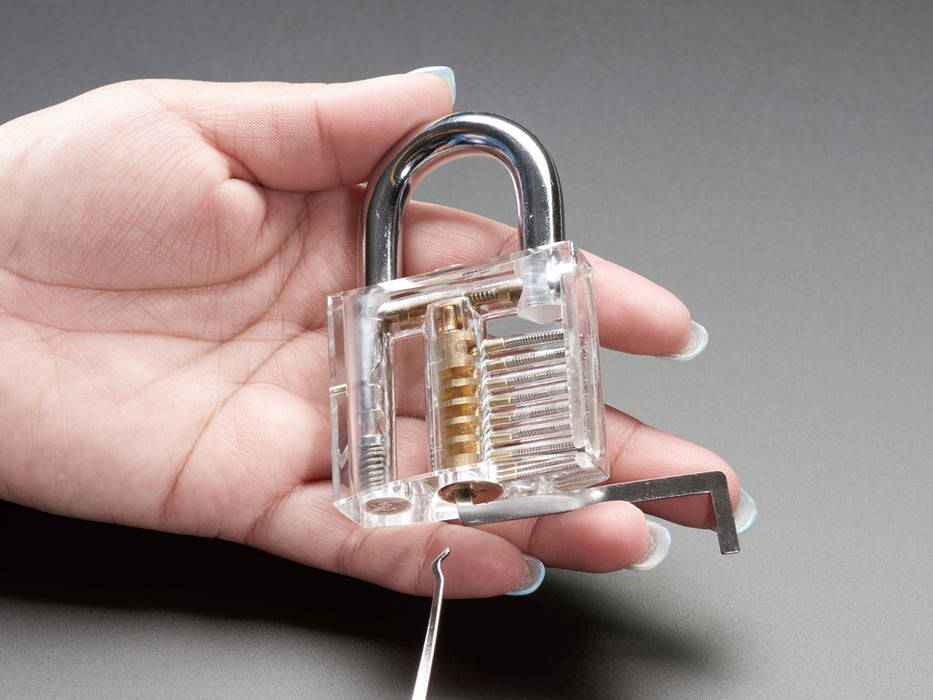 Array of many lock picks with plastic handles, plus wrenches