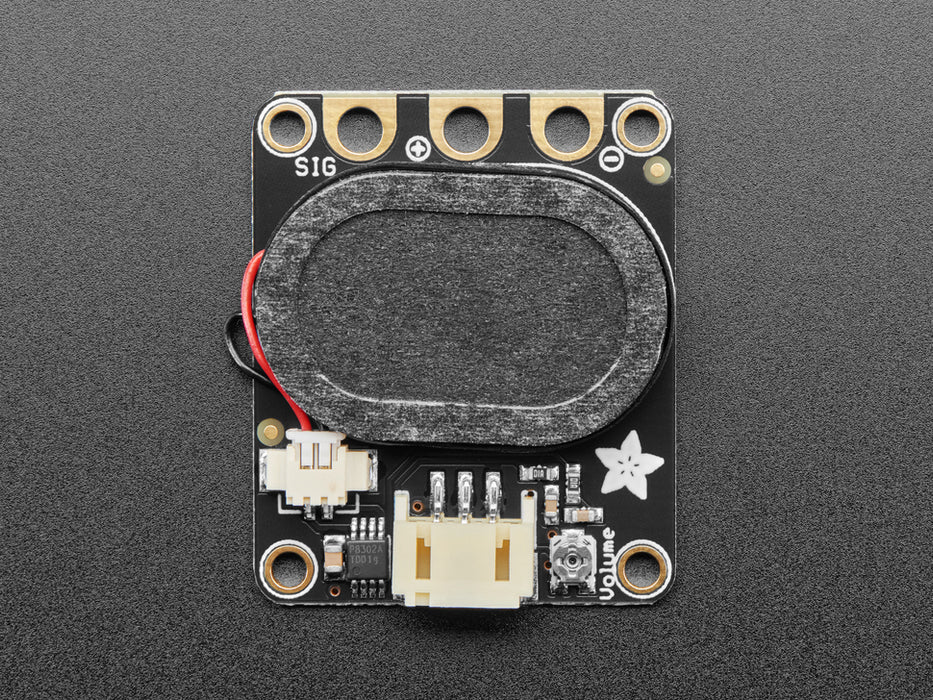 Top view of a black speaker breakout board connected to a round microcontroller via alligator clips. A music note animation emits from the speaker.