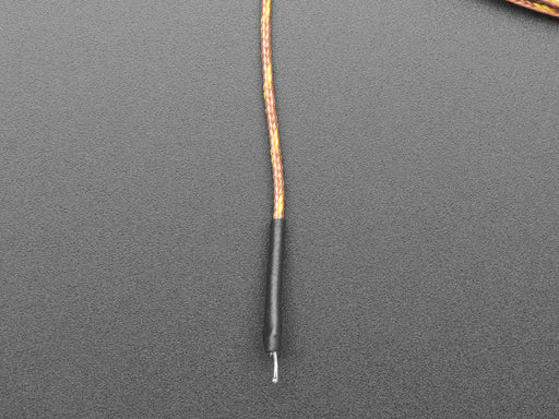 Angled shot of a coiled up 5m Thermocouple Type-K Glass Braid Insulated wire. 