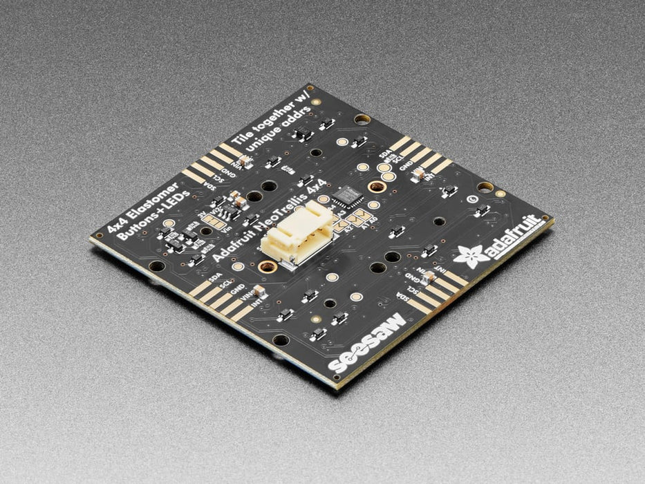 Hand pressing buttons that light up on a Adafruit NeoTrellis RGB Driver PCB for 4x4 Keypad.