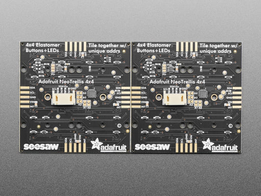 Hand pressing buttons that light up on a Adafruit NeoTrellis RGB Driver PCB for 4x4 Keypad.