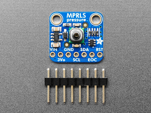 Angled shot of small, blue square-shaped pressure sensor breakout board.