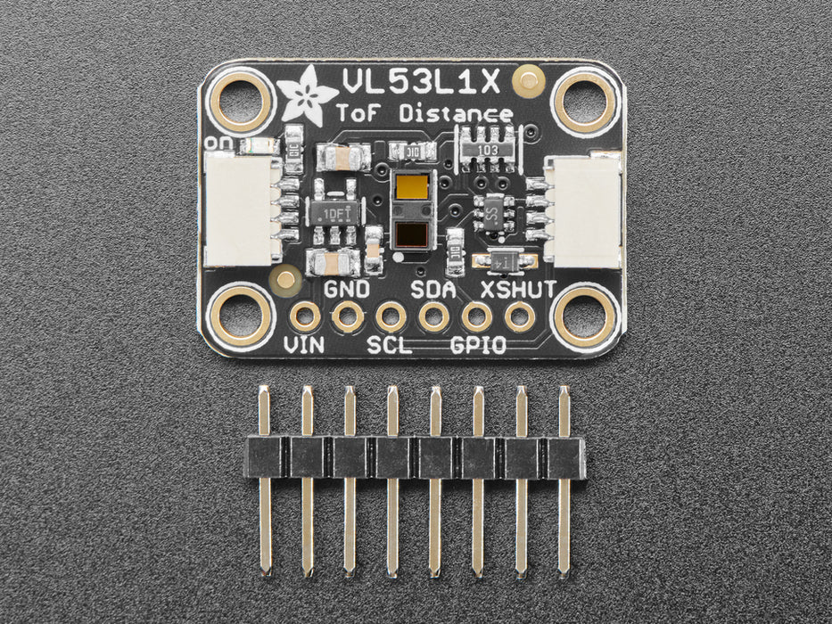 Top view of Adafruit VL53L1X Time of Flight Distance Sensor hooked up to an OLED display. A white manicured hand waves at the sensor, and the OLED displays the distance.