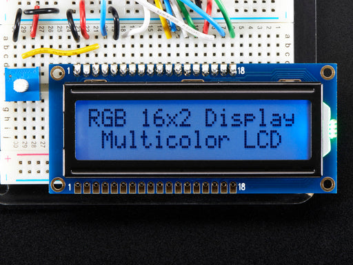 LCD wired on breadboard with backlight changing color with text displayed: "RGB 16x Display Mulitcolor LCD"