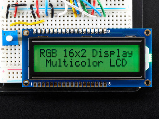 LCD wired on breadboard with backlight changing color with text displayed: "RGB 16x Display Mulitcolor LCD"