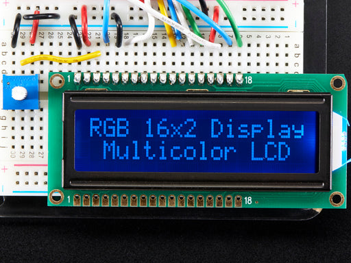 LCD wired on breadboard with backlight changing color with text displayed: "RGB 16x2 Display Mulitcolor LCD"