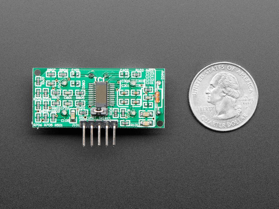 Video of a woman's hand moving toward ultrasonic sonar distance sensor plugged into a half-size breadboard. An OLED screen displays the distance between the woman's hand and the sensor.