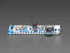 Angled shot of a Adafruit Feather nRF52840 Express. 