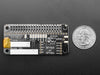 Angled shot of rectangular microcontroller with OLED screen.