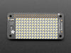 Top down view of a Adafruit CharliePlex LED Matrix Bonnet illuminating cool white. 