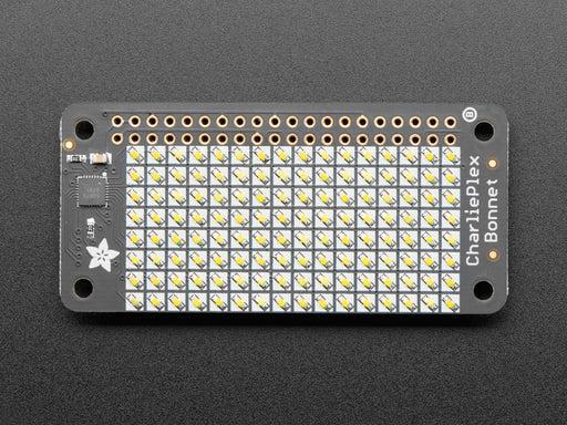 Top down view of a Adafruit CharliePlex LED Matrix Bonnet illuminating cool white. 