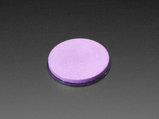 Angled shot of round purple disc of fluorescent paint.