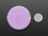 Angled shot of round purple disc of fluorescent paint.