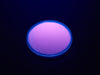 Angled shot of round purple disc of fluorescent paint.