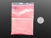 Angled shot of plastic baggy containing red thermochromic pigment powder. 