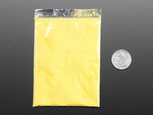 Angled shot of clear baggy containing yellow thermochromic pigment powder.