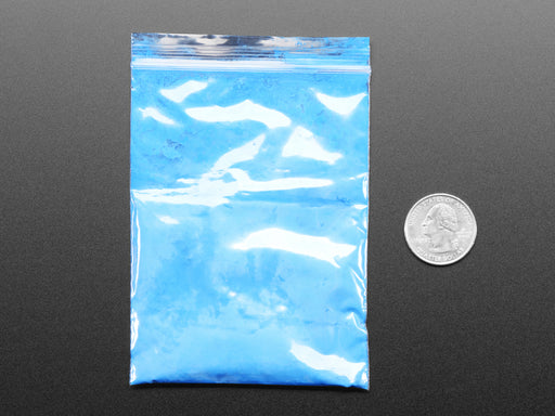 Angled shot of clear baggy containing blue thermochromic pigment powder.