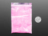 Angled shot of clear baggy containing pink thermochromic pigment powder.