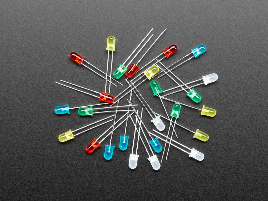 scattered pile of multi colored unlit LEDs 