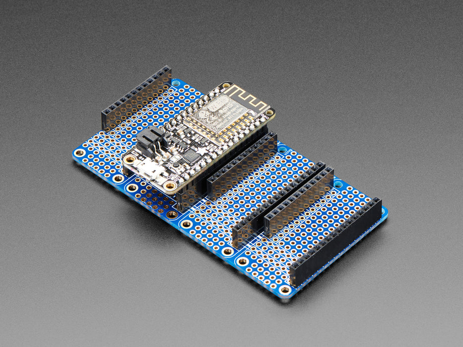 Angled shot of a Adafruit Quad Side-By-Side FeatherWing Kit with a bonnet connected. 